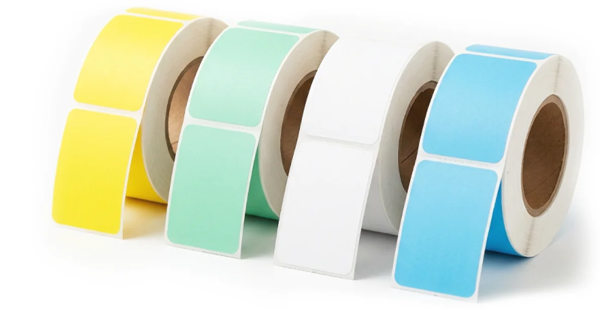 Rolls of blank thermal labels in yellow, mint green, white and blue.